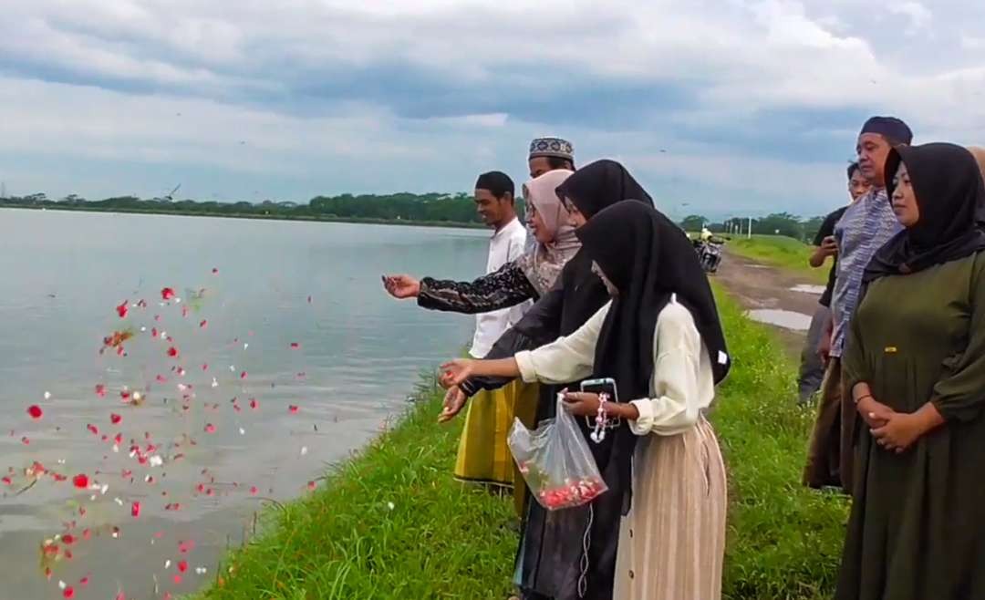 Korban lumpur Sidoarjo tabur bunga di atas tanggul (Foto : Aini/Ngopibareng.id)