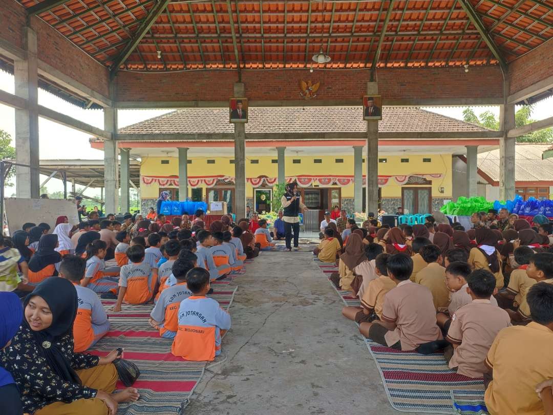 Bupati Ikfina saluran bantuan alat tulis untuk pelajar yang sekolahnya terdampak banjir. (Foto: Deni Lukmantara/Ngopibareng.id)