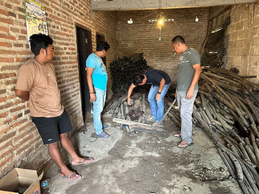 Polisi menggeledah rumah kontrakan yang dijadikan penyimpanan kabel Telkom curian. (Foto: Dokumentasi Polsek Jenggawah)