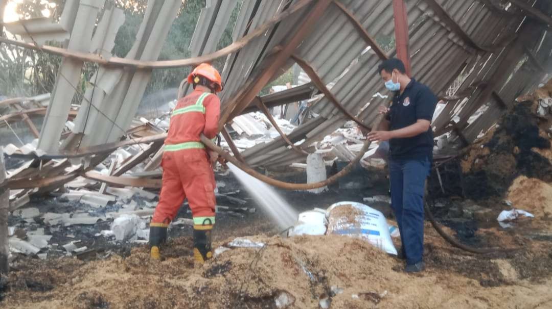 Petugas pemadam kebakaran Tuban melakukan upaya pembasahan kandang ayam yang terbakar (Foto: dok. Damkar Tuban)