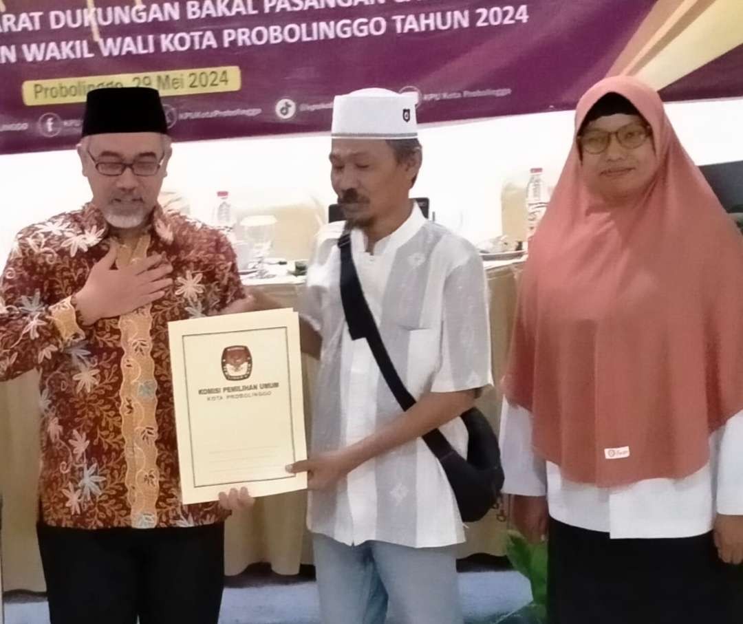 Ketua KPU, Ahmad Hudri (kiri) saat menyerahkan hasil rekapitulasi syarat dukungan minimal bagi paslon independen Eva dan Saiful, Rabu, 29 Mei 2024 lalu. (Foto: Ikhsan Mahmudi/Ngopibareng.id)