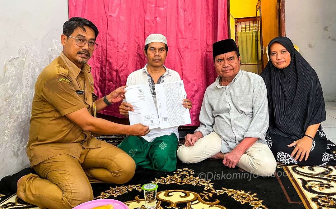 Keluarga salah satu calon jemaah haji asal Sidoarjo saat terima akta kematian. (Foto: Kominfo Sidoarjo)