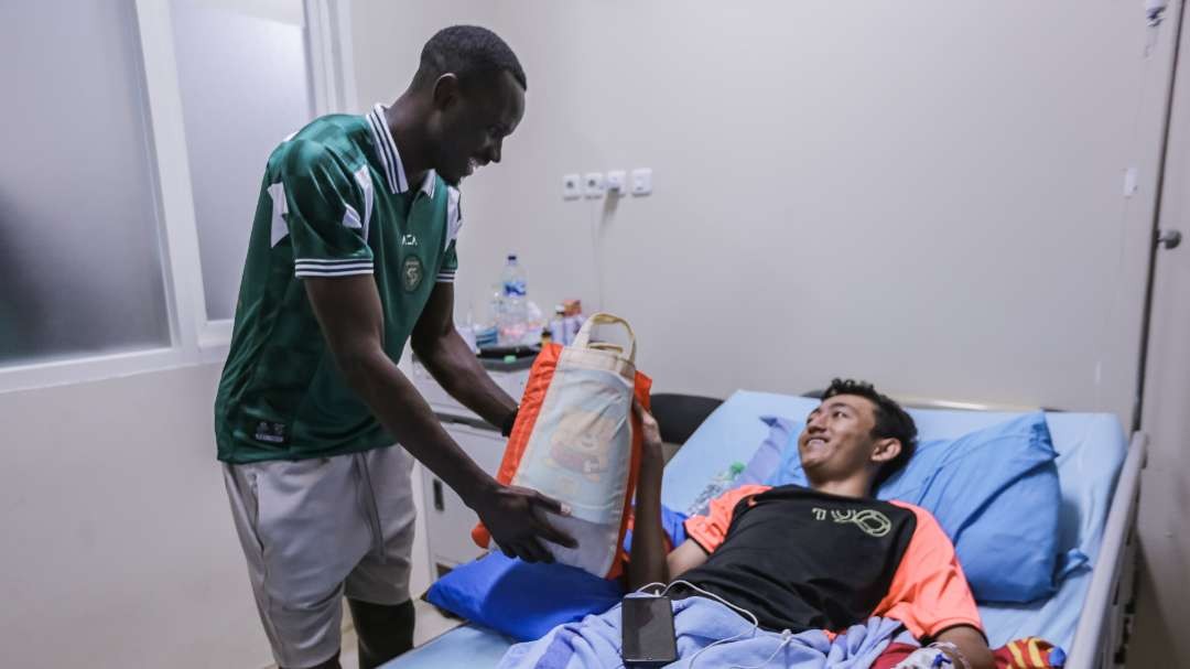 Pemain Persebaya, Flavio Silva saat menjenguk salah satu pasien di RSUD BDH, Surabaya, Selasa 18 Juni 2024. (Foto: Persebaya)