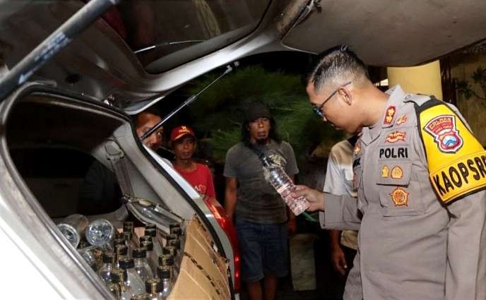 Kapolres Situbondo AKBP Dwi Sumrahadi memeriksa tiga ratusan botol minol atak Bali diamankan dari penggerebekan tiga rumah warga. (Foto: Dok. Satreskrim Polres Situbondo)