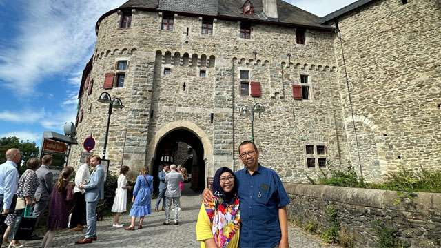 Sukemi, penulis, foto bersama istri di depan Schloss Burg atau Kastil Burg, di wilayah Nordrhein-Westfalen, Jerman. (Foto:Ngopibareng.Id/Sukemi)