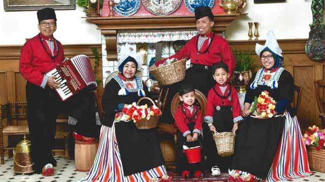 Sukemi, penulis (paling kiri) foto bersama keluarga dengan pakaian tradisional di  Volendam, Belanda. Volendam adalah sebuah desa nelayan sekaligus destinasi wisata yang terkenal di Belanda. (Foto:Ngopibareng.Id/Sukemi)