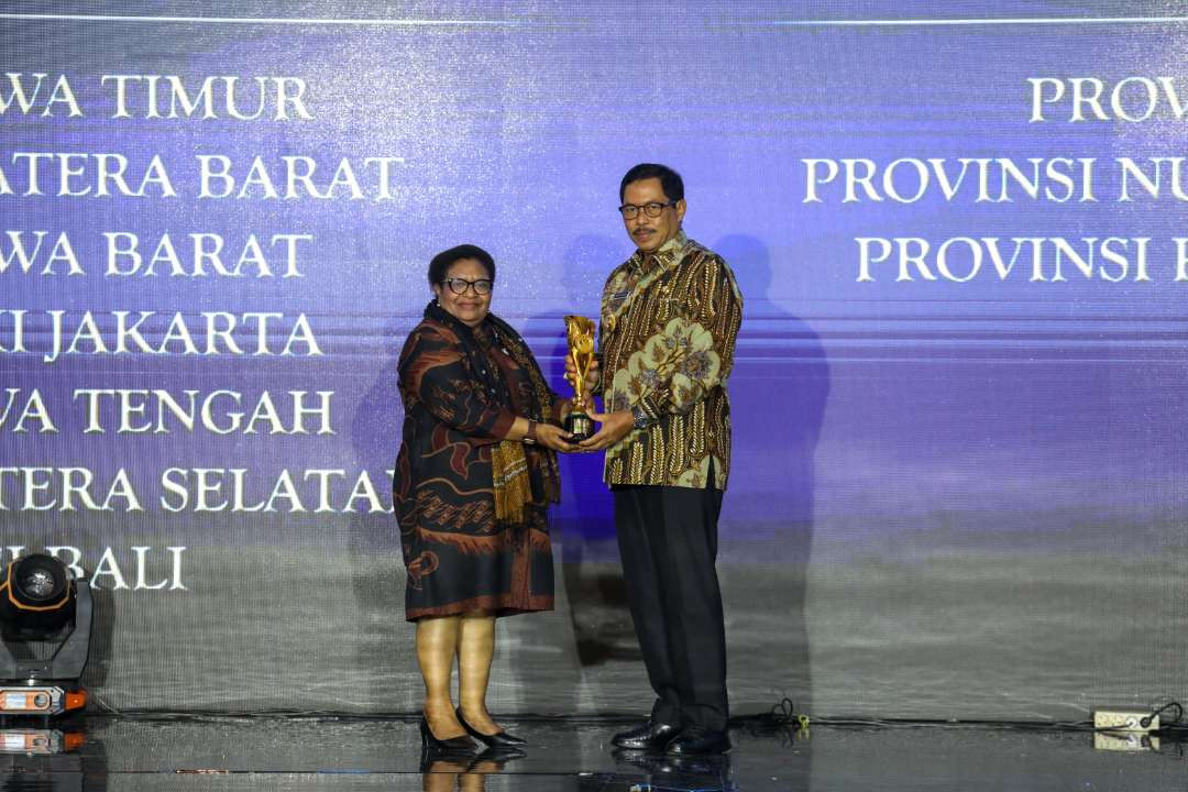 Wakil Menteri Dalam Negeri, Ribka Haluk, menyerahkan penghargaan kepada  Pj Gubernur Jawa Tengah, Nana Sudjana, di Hotel Mercure Mirama, Surabaya, pada Kamis 5 Desember 2024. (Foto: Dok. Pemprov Jateng)