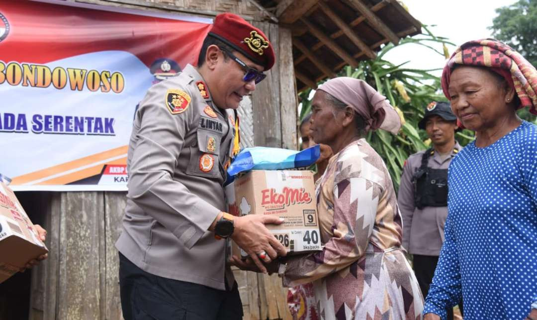 Kapolres Bondowoso AKBP Lintar Mahardhono memberikan bantuan sembako pada emak-emak di Desa Sukorejo Kecamatan Sumberwringin.(Foto:Guido/Ngopibareng.id)