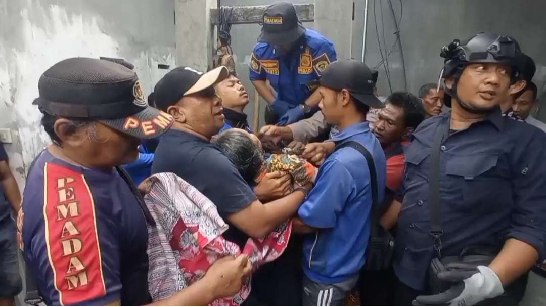 Warga dan petugas dari Satpol PP dan Damkar Kabupaten Madiun mengevakuasi Tuminem 75 tahun warga setempat. (Foto: Istimewa)