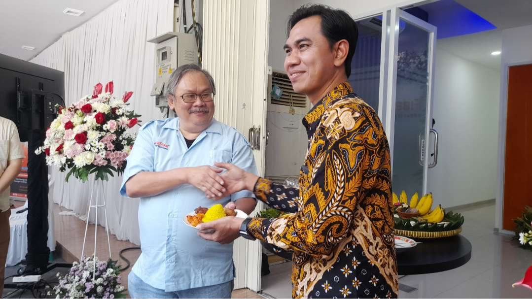 Marcelus Ardiwinata, Commerce and Network Director FiberStar (kiri) dan Ahriful Ahyar, Branch Manager Jawa Timur FiberStar (kanan) dalam pemotongan tumpeng saat peresmian cabang baru. (Foto: Yunus Ar-Rahman/Ngopibareng.id)